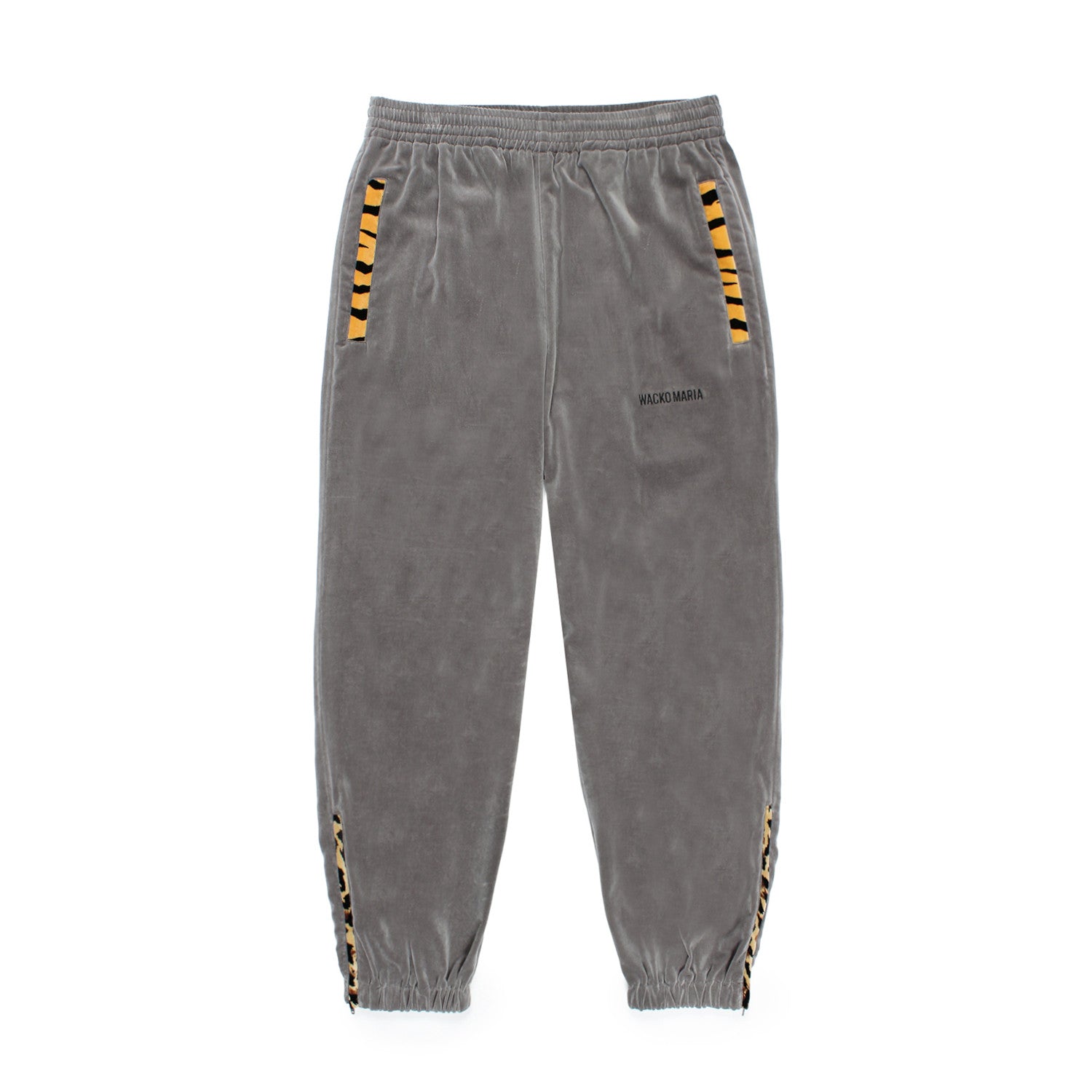 WACKO MARIA（ワコマリア）2025年秋冬コレクション「天国東京」から、VELVETEEN TRACK PANTS (TYPE-3) 25FW-WMO-TP03のグレーを入荷致しました。グレーのベロア生地をベースに、ブラック、ホワイトの切り替えしと、随所にレオパード柄やタイガー柄の生地を用いる事により、色気溢れるアイテムに仕上がっています。
左ももに「WACKO MARIA」のロゴは刺繍。